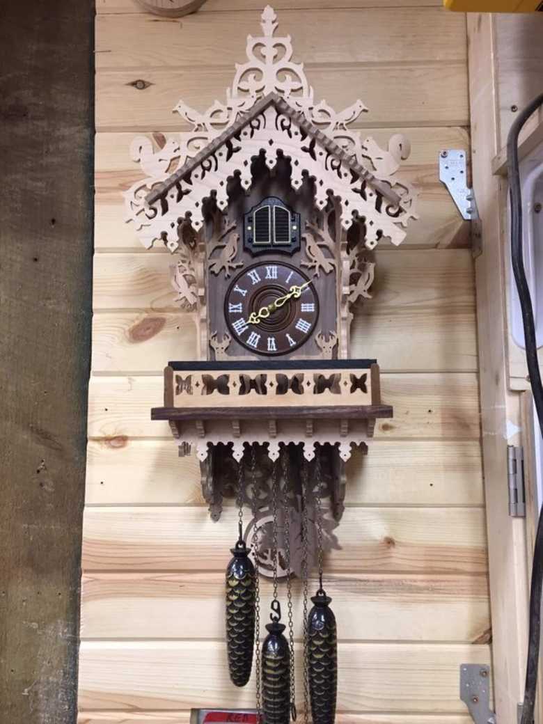 old wooden handmade clock for in home decor with accorn like accents